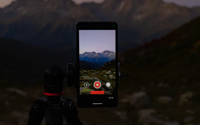Phone on a tripod overlooking a mountain landscape